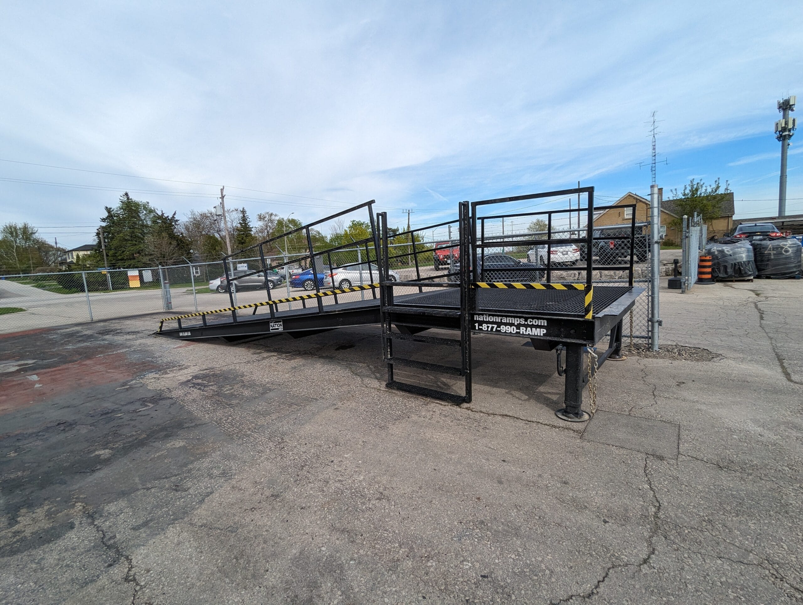 NATION RAMPS PORTABLE LOADING DOCK RAMP IN THE FIELD WITH AUTO ZONE